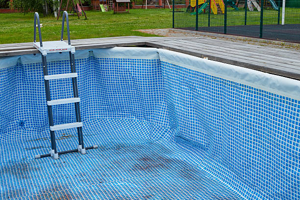 istock Swimming pool without water in backyard before season opening 2239308044