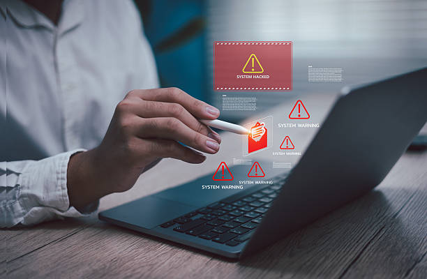 istock Close-up of businessman using pen pointing on laptop inbox e-mail system warning hacking alert icons, concept cybersecurity risk, software error malware attack, data breach, and online safety threats 2239308131