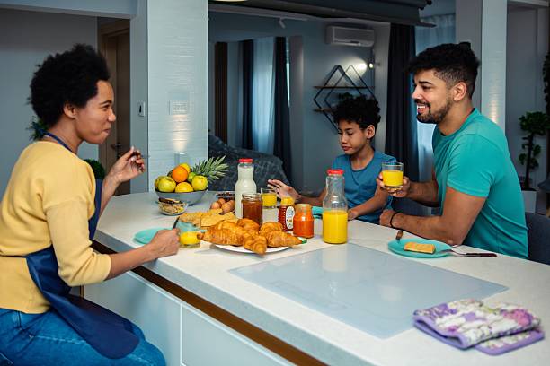istock Happy black family having breakfast in the kitchen 2239317601