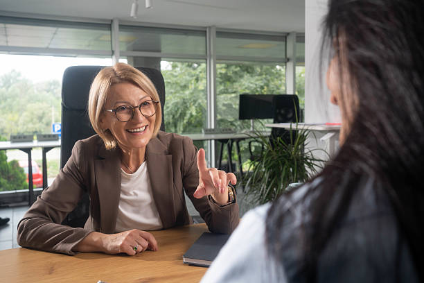 istock Happy insurance agent talking to her customer in the office. 2239320491