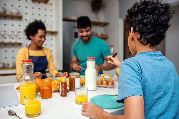 istock Happy black family having breakfast in the kitchen 2239322672