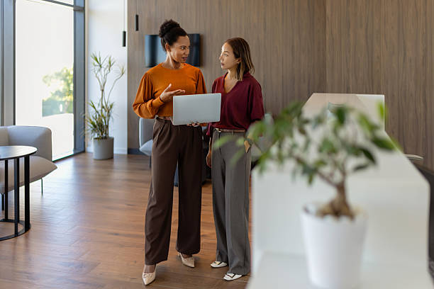 istock Diverse Business Women Collaborating with Laptop in Modern Office 2239324672