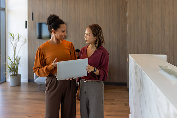 istock Diverse Business Women Collaborating with Laptop in Modern Office 2239324680