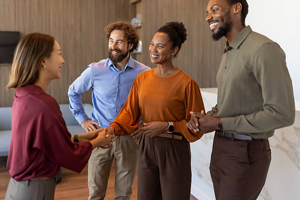 istock Inclusive Workplace: Diverse Team Greeting Each Other with Handshakes in Office 2239324687