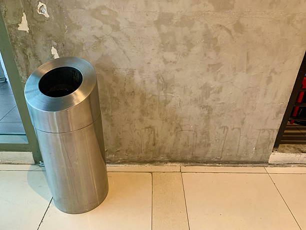 istock Trash can metal against the cement wall copy space 2239325562