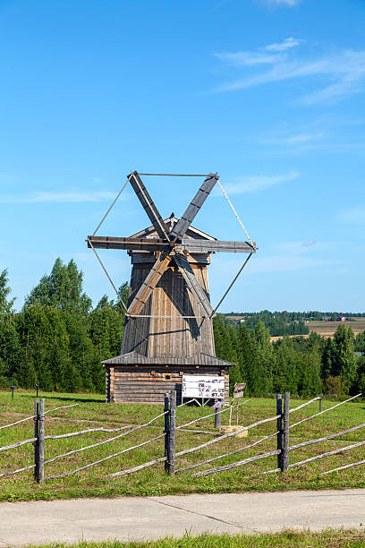 istock Historic Wooden Windmill with Large Blades under Blue Sky 2239327320