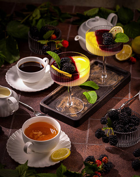 istock Panna cotta desserts with blackberries and fresh hot drinks 2239328274
