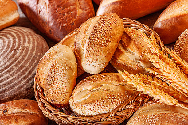 istock Fresh baked bread. Assorted bakery products loafs of bread and rolls... 2239329343