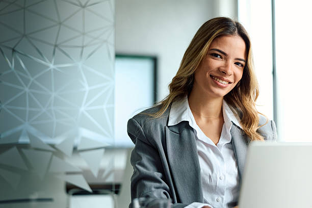 istock Professional businesswoman smiling confidently while working on laptop in office 2239329356