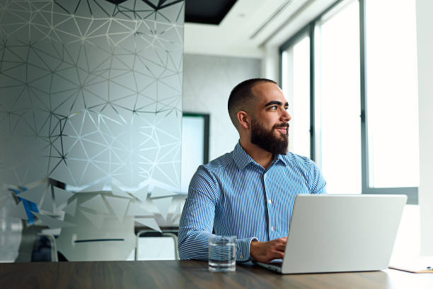 istock Thoughtful businessman working on laptop in modern office 2239329377