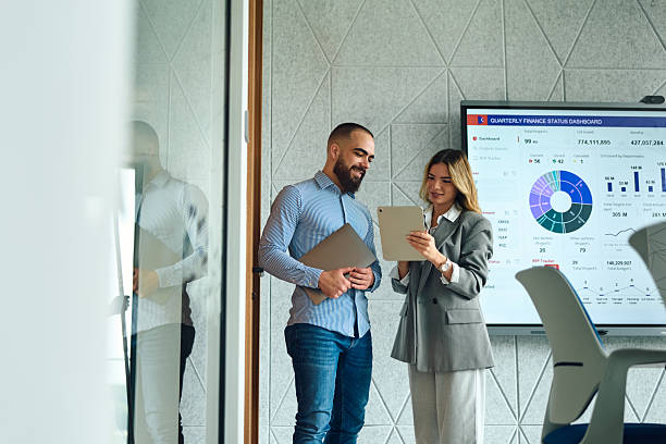 istock Business partners analyzing company data on digital tablet 2239329380