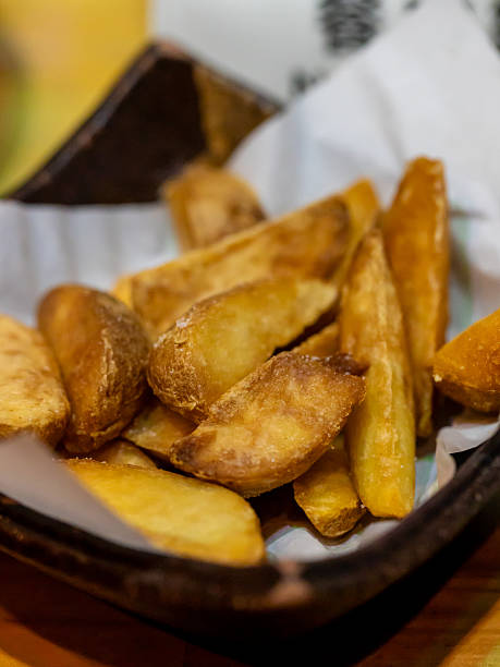 istock Crispy Golden Fried Potato Wedges Served in Rustic Basket 2239333876