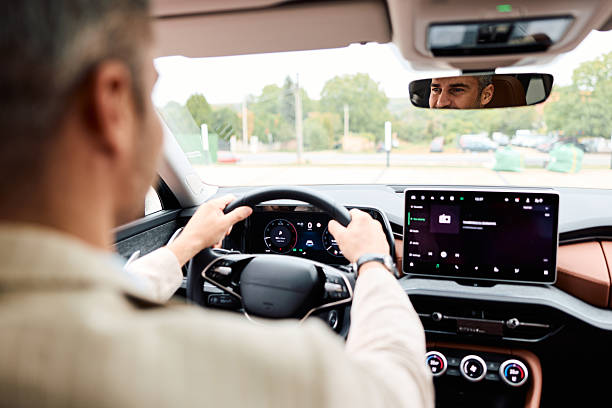istock Man driving modern car looking in rearview mirror 2239334756