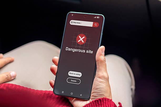 istock A woman visit a website indicates malware, phishing or deceptive practices on her smartphone. Dangerous site warning on smartphone. 2239339446