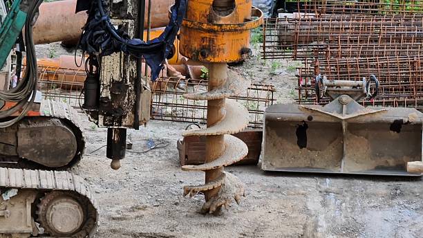 istock Heavy Machinery Operating at a Construction Site Equipped with an Auger Drill for Excavation 2239341410