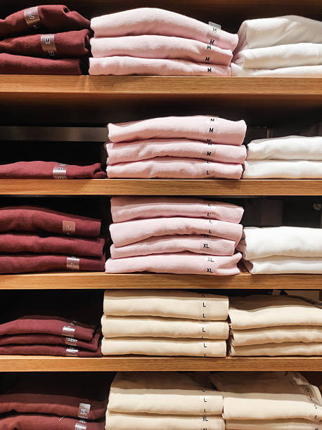 istock Neatly folded clothes are arranged on wooden shelves 2239341612