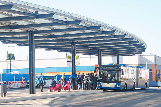 A group of students, commuters and tourists boarding a bus at a central bus station in Hanau, Hesse, Germany.