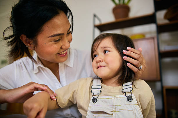 istock Mother smiling warmly at her daughter while sitting together in bright home interior 2239350025