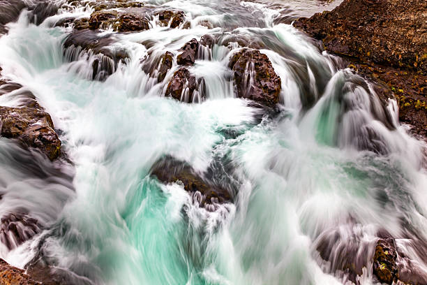 Rapid streams of cold meltwater flow into the ocean. Iceland. Snaefellsnes Peninsula.