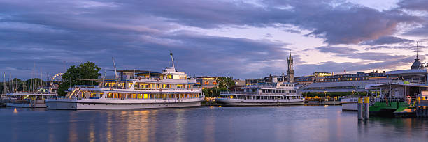 istock Evening reflections over Lake Constance in Konstanz, Germany with illuminated boats 2239353230