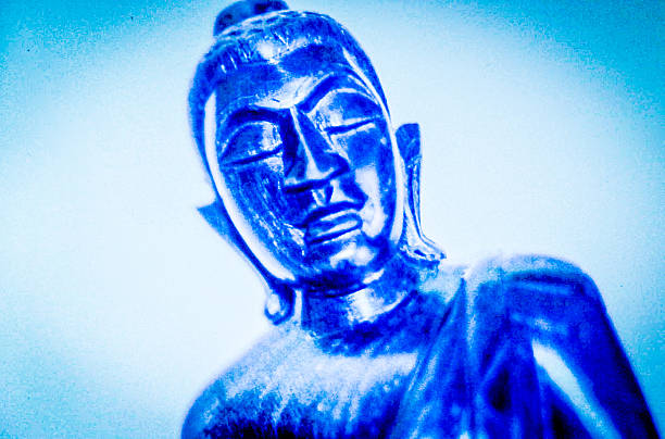 istock Face of a wooden Buddha figure 2239353596