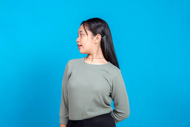 istock A young woman gazes thoughtfully to the side with a subtle, contemplative expression. Her slightly parted lips and focused gaze suggest curiosity or quiet contemplation. 2239353966