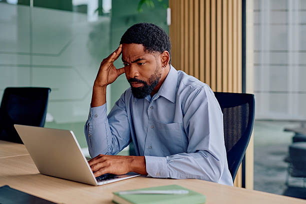 istock Businessman feeling pressure working on laptop in office 2239356958