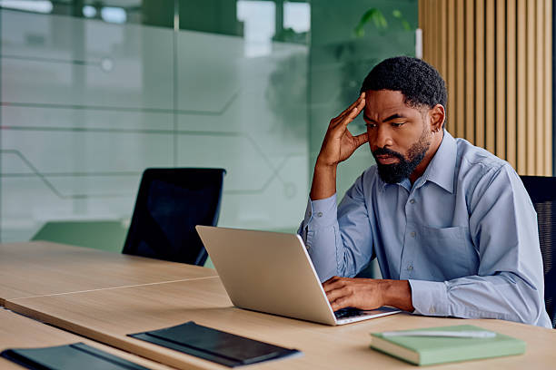 istock Stressed businessman contemplating strategy while working on laptop 2239356964