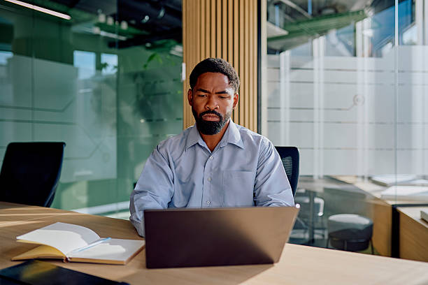 istock Black businessman working on laptop in modern office 2239358058