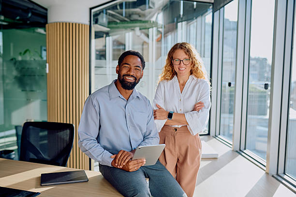 istock Diverse business people smiling in modern office environment 2239358391