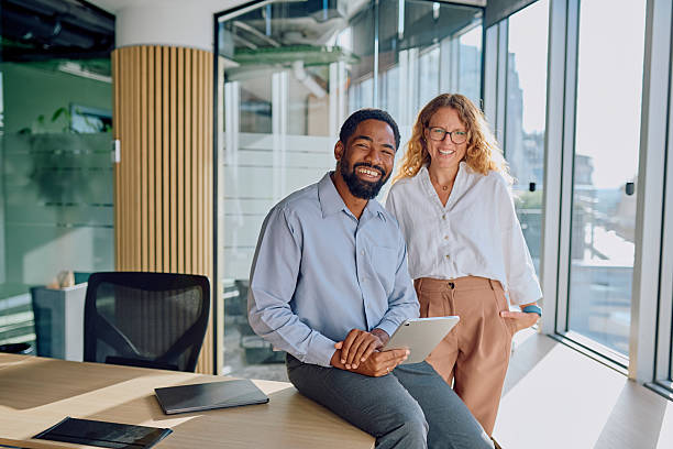 istock Diverse business colleagues smiling in modern office 2239358405