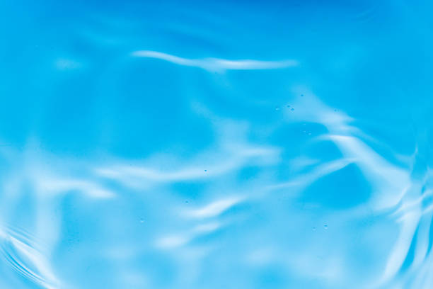 Blue water background with ripples wave reflection.Abstract water texture on sea.Concept freshness for Cosmetic product,Summer pool with clean liquid surface,Wellness of natural texture for template