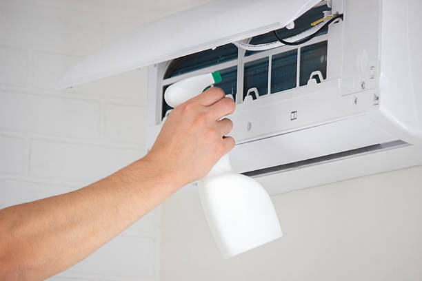 istock Hands Cleaning the Air Conditioner Unit Filter with a Disinfectant Spray Bottle 2239359002