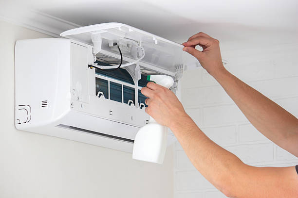 istock Hands Cleaning the Air Conditioner Unit Filter with a Disinfectant Spray Bottle 2239359015