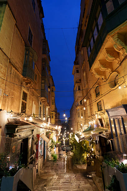 istock Blue-Hour Stepped Restaurant Street Draped with String Lights and Maltese Balconies 2239366083