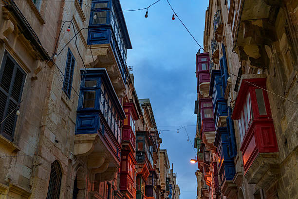istock Colorful Maltese Balconies Facing Each Other with Festoon Lights at Dusk 2239366141