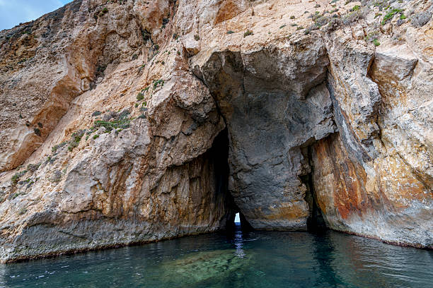 istock Dramatic Twin-Entrance Sea Cave in Towering Coastal Limestone Cliff 2239367376
