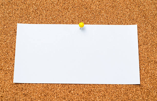 istock Single white note paper with push pin on bulletin board 2239372484