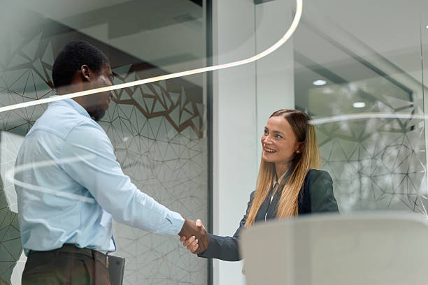 istock Diverse business professionals sealing agreement with handshake in office 2239372513