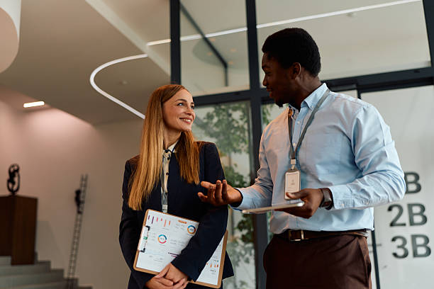 istock Business colleagues discussing data charts in office hallway 2239372649