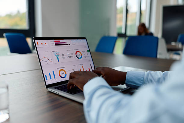 istock Person analyzing business data on laptop in office meeting 2239372701
