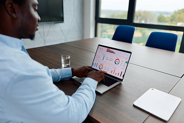 istock Black businessman analyzing financial data on laptop in office 2239372704