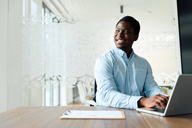 istock Young Black man working on laptop in modern office 2239373080