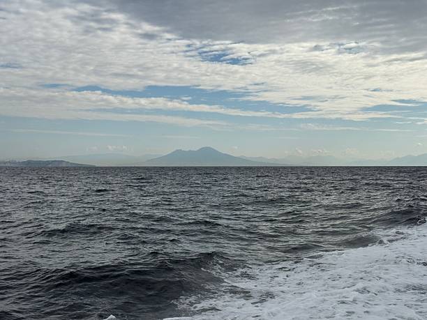 istock Vast Cloudy Seascape with Distant Vesuvius Volcano. 2239373156