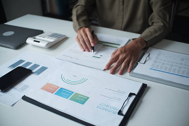 istock Businessman reading report in office desk analyse data for plan project 2239374156