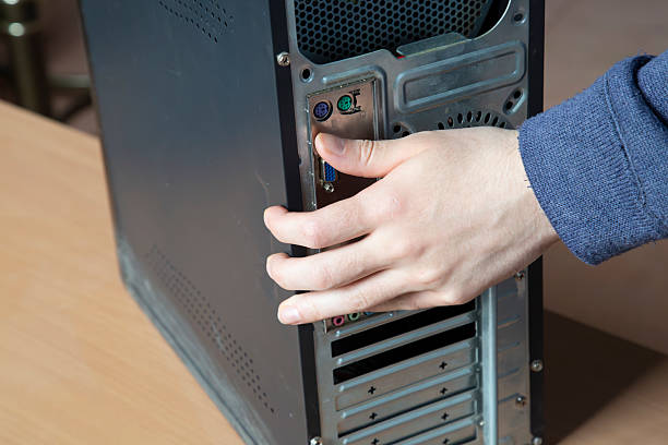 istock Computer repair. The technician inspects the computer for further repairs. 2239380431