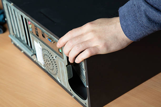 istock Computer repair. The technician inspects the computer for further repairs. 2239380582