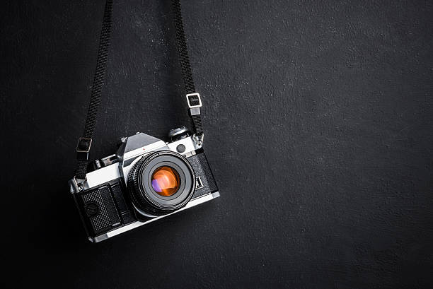 istock Vintage SLR camera hanging on the wall 2239380980