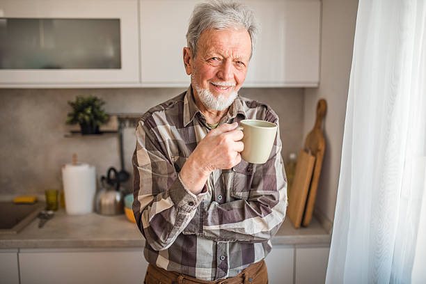 istock Portrait of a senior man looking directly at the camera while drinking coffee in the kitchen 2239382385