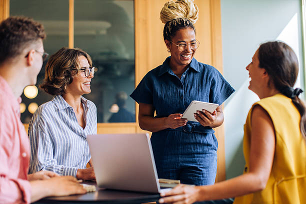 istock Diverse coworkers discuss ideas at a meeting with laptops and tablets 2239383955